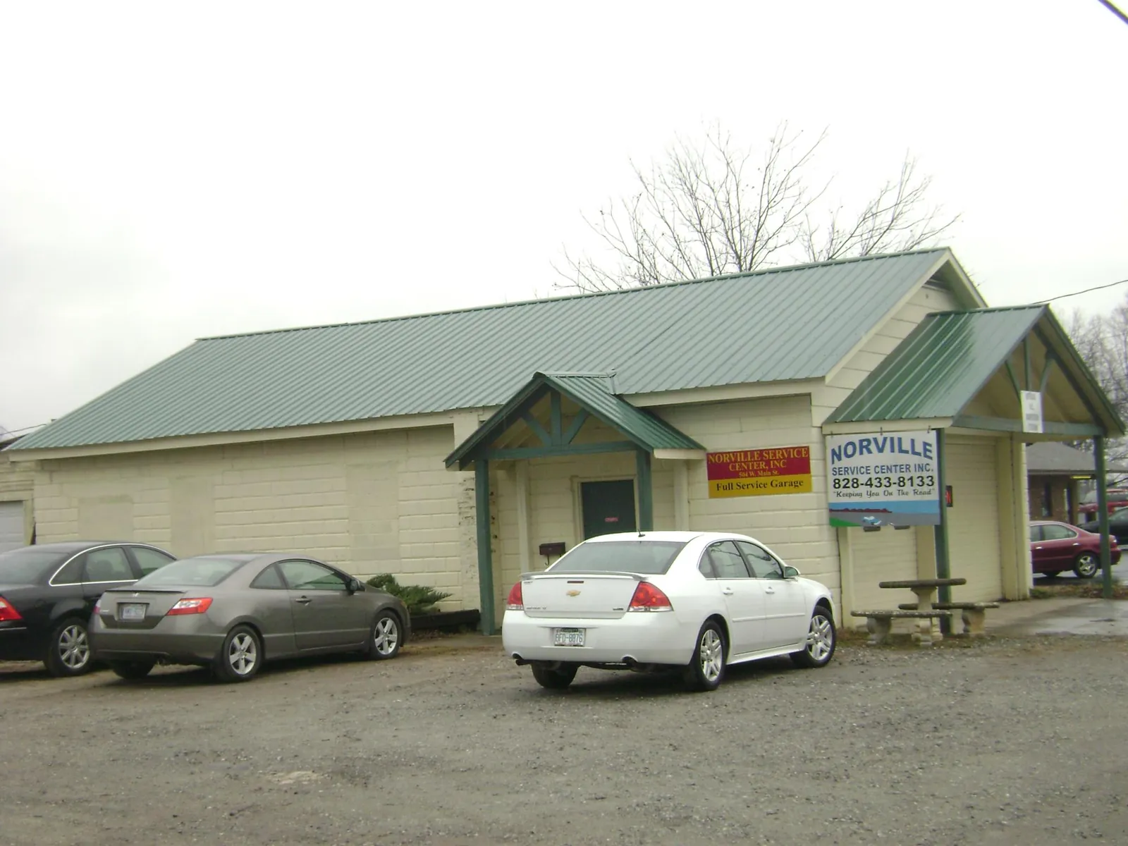 Green metal roof on a service garage with a covered entry in Bellevue